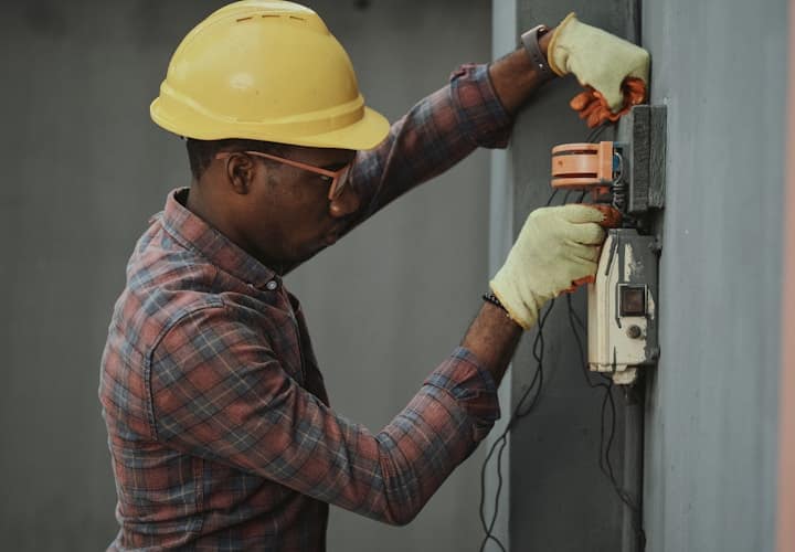 An electrician wiring a new build on a construction site.